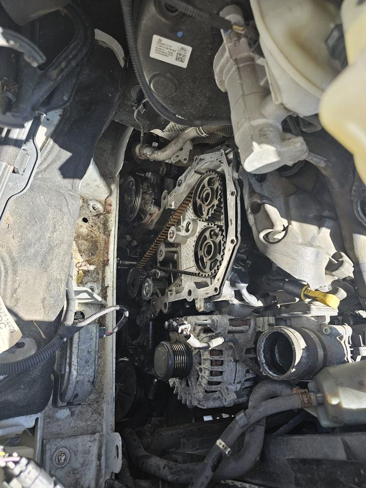 An engine bay opened up to reach the belt drive