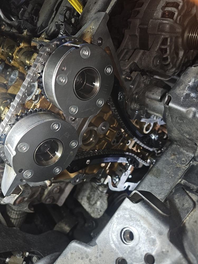 A timing chain and cam sprockets exposed on an engine